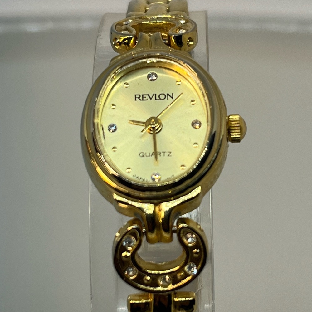 REVLON! Very pretty elegant watch with 10 gemstones and gold band! Size 6 3/4
